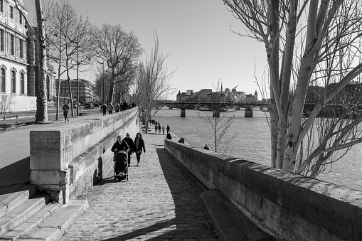 Walkers on the right bank of the Seine in Paris, France,