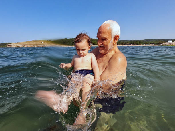 istock Baby boy swimming with grandfather 1383011502