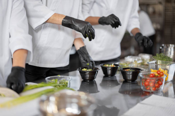 istock Chefs prepare takeaway food in professional kitchen 1383014126