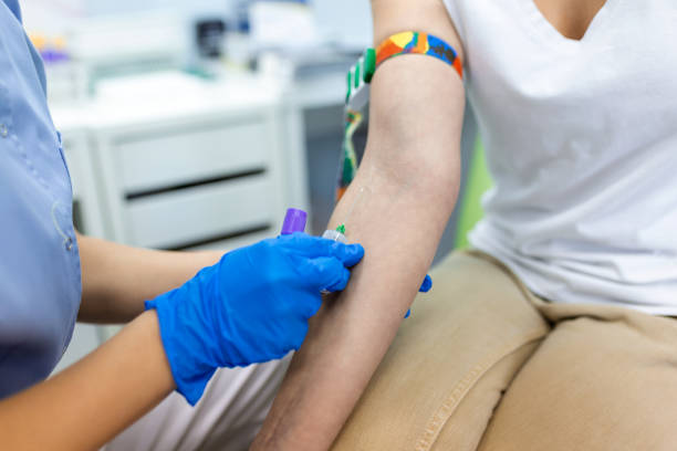 istock Medical technologist doing a blood draw services for patient. lab assistant with sterile rubber gloves taking blood sample from patient. 1383015377