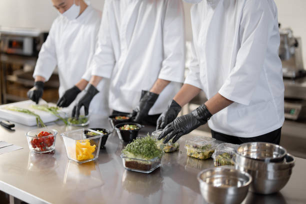 istock Chefs prepare takeaway food in professional kitchen 1383015578