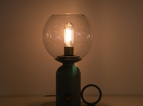 Glowing Hanging Light Bulb in Dark, very nice photo with lot of details. It can be used for various purposes.