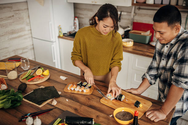 istock Couple making sushi for lunch 1383018365