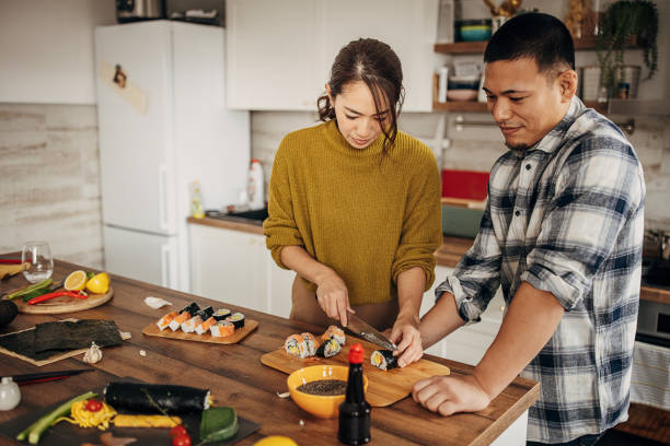istock Couple making sushi for lunch 1383018485