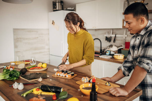istock Couple making sushi for lunch 1383018535