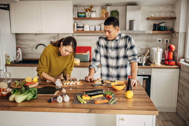 istock Couple making sushi for lunch 1383018774