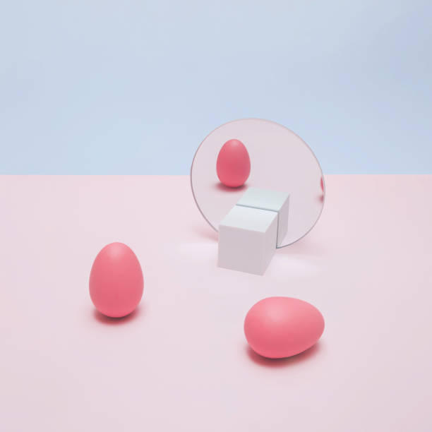istock Trendy pastel Easter concept with pink eggs and mirror reflection. Fun, minimal aesthetic. 1383020882