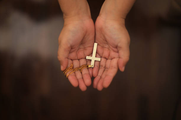Hands holding cross, hope concepts, pray and peace