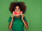 Studio portrait of a beautiful afro girl with watermelon