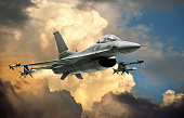 istock F-16 Fighting Falcon fighter jet (model) against dramatic clouds 1383022984