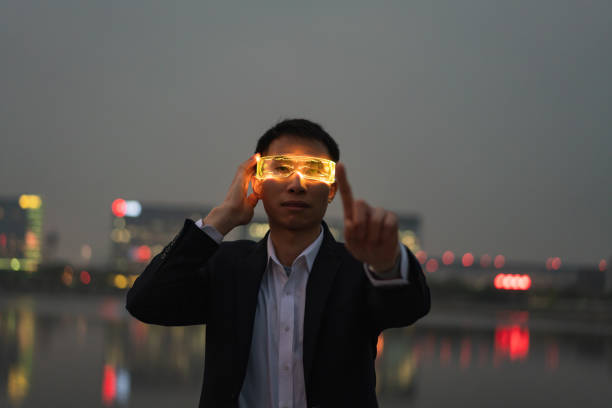 Man with smart glasses experiencing augmented reality game under city lights at night
