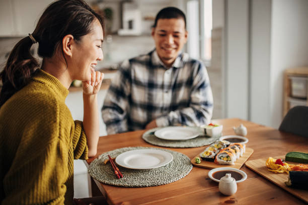 istock Couple having sushi at home 1383027840