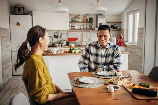 istock Couple having sushi at home 1383027895