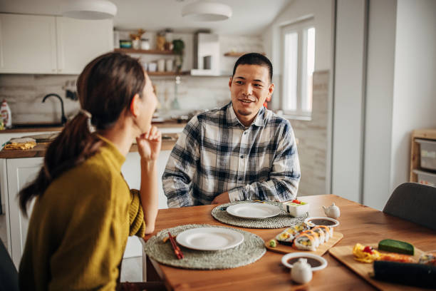istock Couple having sushi at home 1383027952