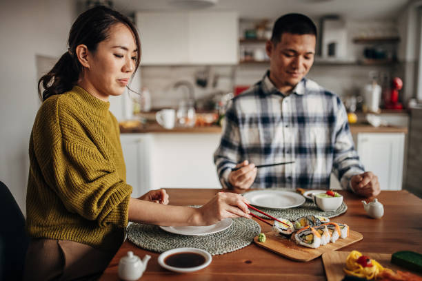 istock Couple having sushi at home 1383028184