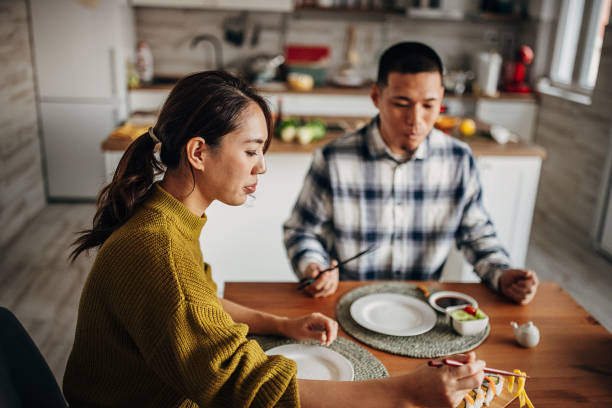 istock Couple eating sushi at home 1383028448