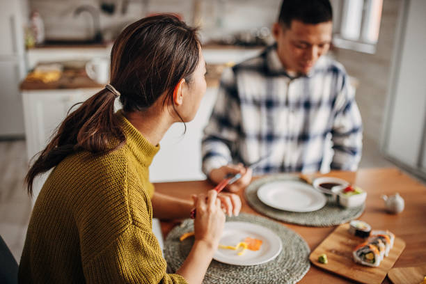 istock Couple eating sushi at home 1383030339