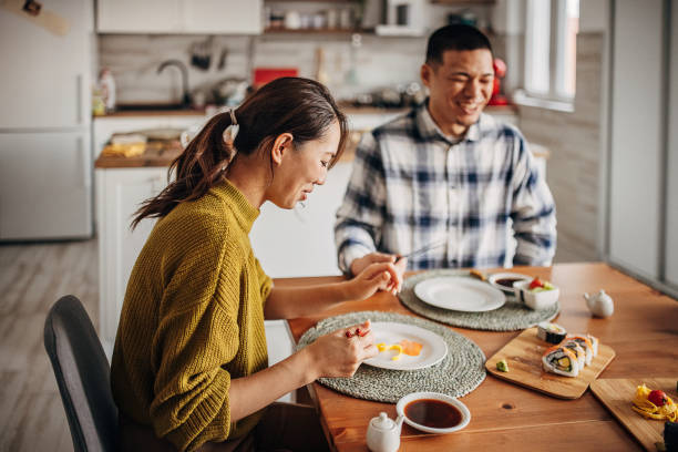 istock Couple eating sushi at home 1383030942