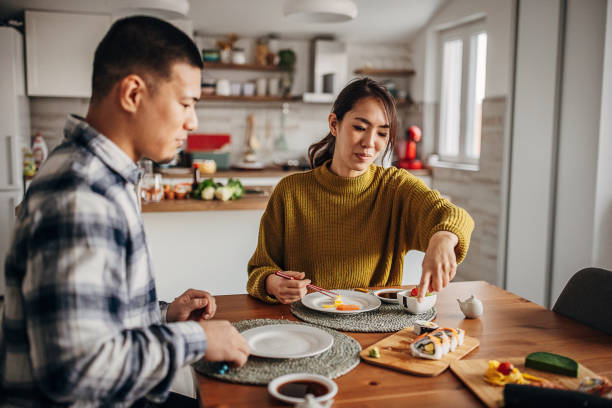 istock Couple eating sushi at home 1383030998