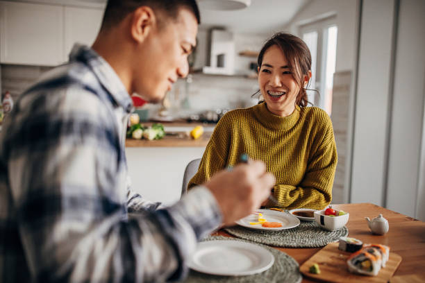 istock Couple eating sushi at home 1383031193