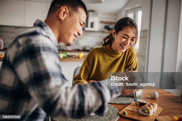 Couple Eating Sushi At Home Stock Photo - Download Image Now - Couple - Relationship, Eating, Domestic Life