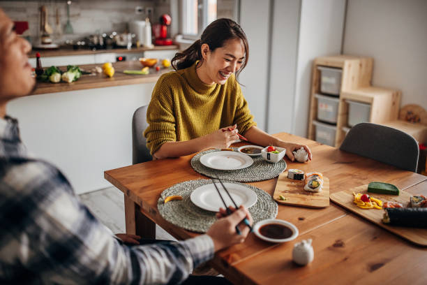 istock Couple eating sushi at home 1383031468