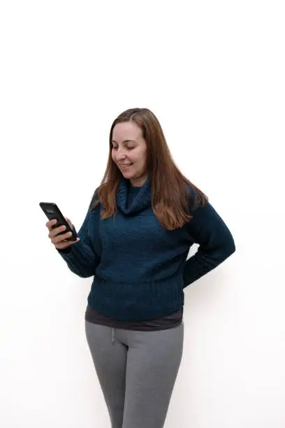 Woman watching video on smartphone on white background