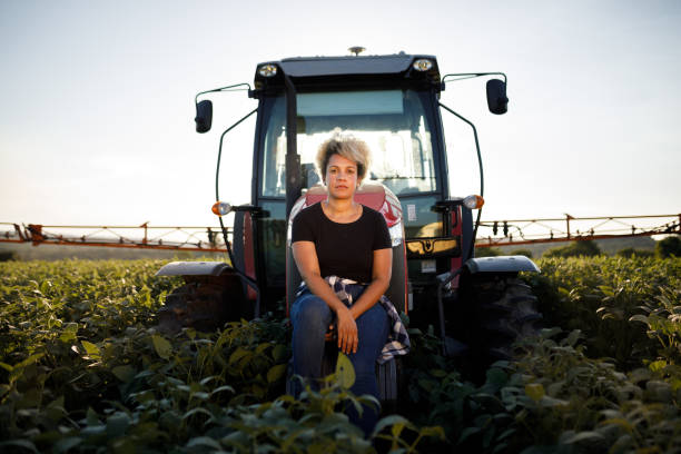 Farmer sitting outside a combine in the field