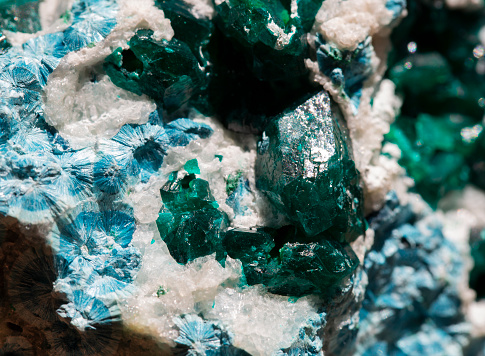 raw emerald gemstone (mineral beryl)  with inclusions mined in Brazil isolated on white