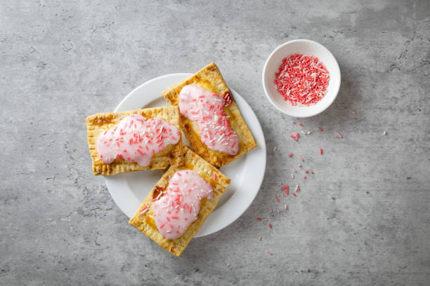istock Cute pink pop tarts with pink icing and sugar sprinkles on top 1383039075