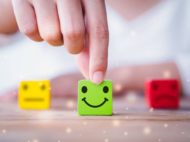istock Customer service satisfaction survey concept. Customer hand choose happy smiley face, blurred neutral and sad face icon on wood cube to survey feedback, business, rating, review, service satisfaction. 1383039697