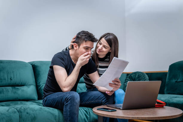 istock Young couple paying bills online 1383045244