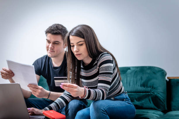 istock Young couple paying bills online 1383045937