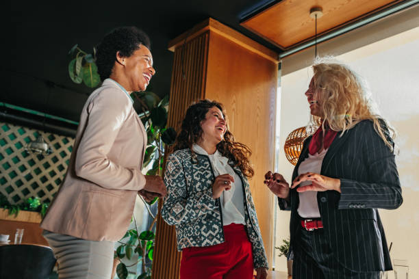 istock Three diverse businesswomen at cafe socializing 1383047412