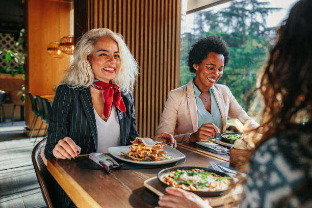 istock Female executives are having discussion during business lunch 1383047416