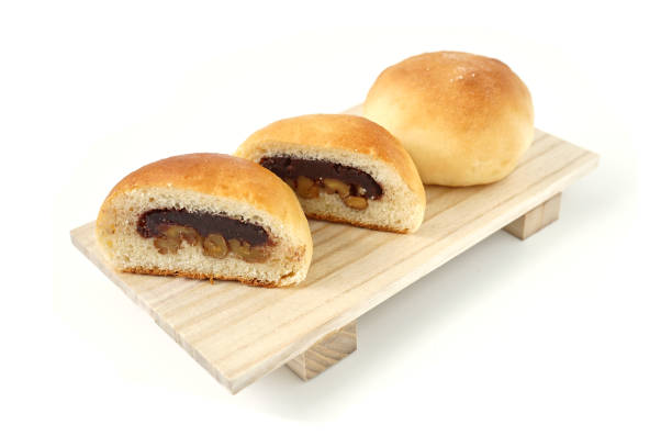 Freshly baked buns lotus red bean cut in half put side by side stock photo