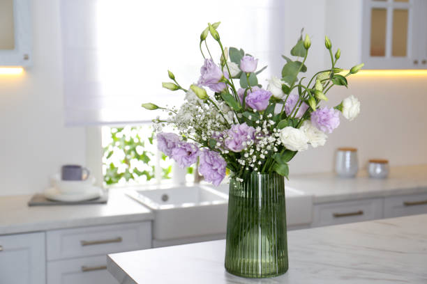 istock Beautiful bouquet with Eustoma flowers on table in kitchen 1383051215