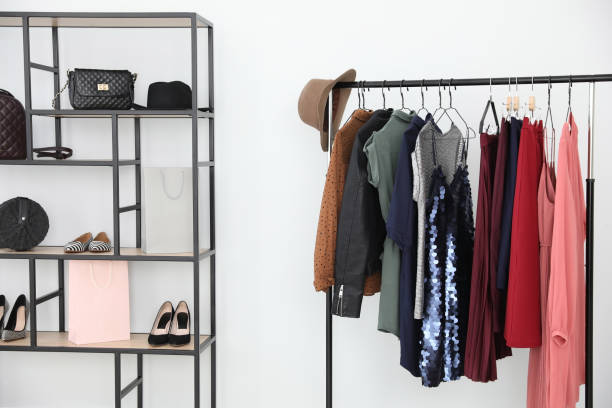istock Different stylish clothes on rack in dressing room 1383051249