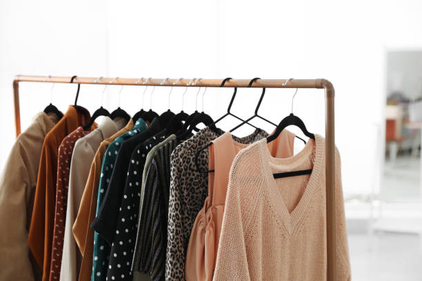 istock Different stylish clothes on rack in dressing room, closeup 1383051260