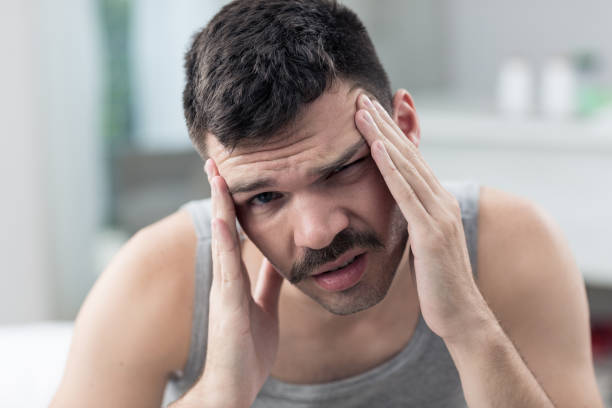 istock Young man with a headache, was sick in bed in bedroom 1383051500