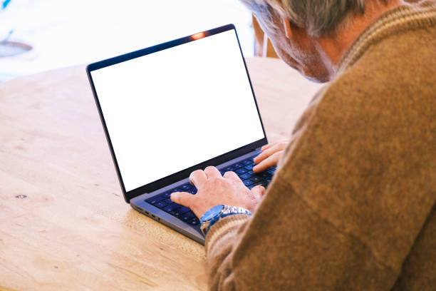 istock Senior man working on laptop at cafe 1383053745