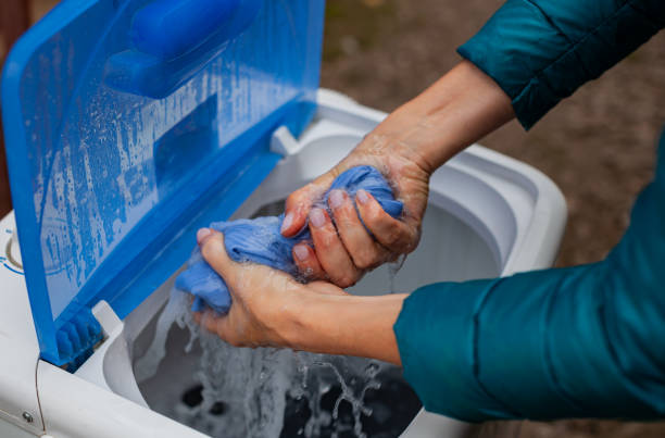 istock hands wringing out a damp item after washing in a washing machine 1383054009
