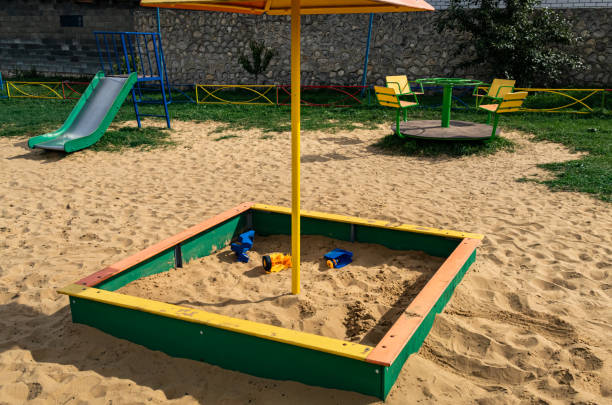 istock sandbox with broken toys in the playground 1383061126