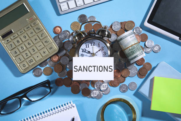 istock Sanctions on business card with a money and business objects. 1383061151