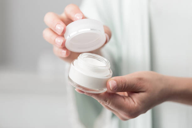 istock Woman holding beauty cream 1383063563