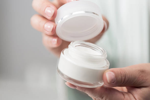 istock Woman holding beauty cream 1383064355