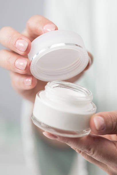 istock Woman holding jar of moisturizer 1383065733