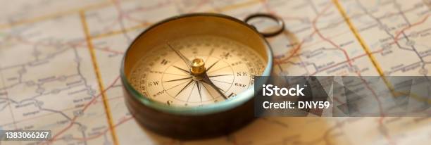 Compass On Road Map Stock Photo - Download Image Now - Navigational Compass, Photography, Close-up