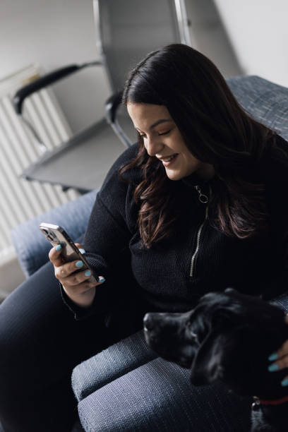 istock Beautiful plus size woman petting her dog 1383068457