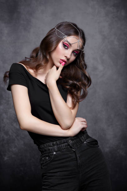 Beauty portrait of young woman. Brunette girl with evening female makeup and black T-shirt stock photo